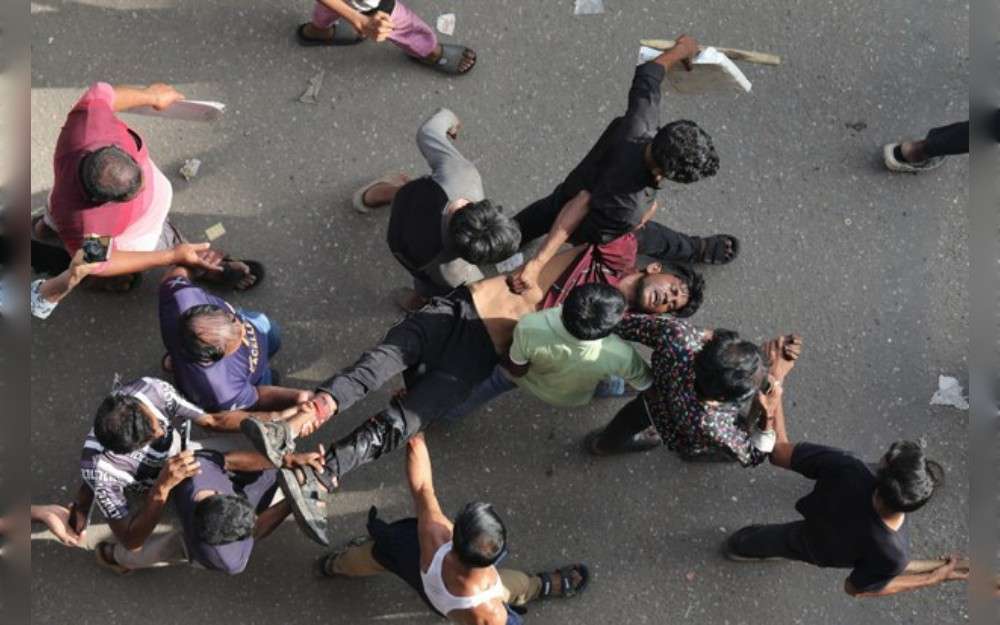 Activists carry a man who was injured during a student protest over a quota system for government jobs in the Jatrabari area of Dhaka, July 18, 2024.Credit: Md. Hasan/BenarNews